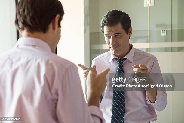 man smiling at his reflection in mirror - vanity stock pictures, royalty-free photos & images
