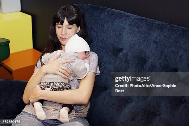 mother holding infant - anne sophie mutter stock-fotos und bilder