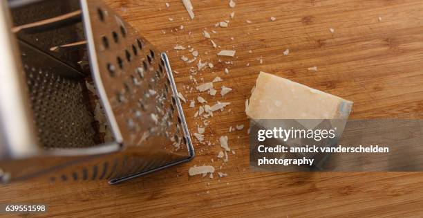 grating parmigiano-reggiano. - grattugia foto e immagini stock