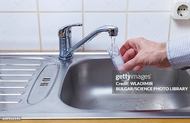 person filling test tube with tap water - running water stock pictures, royalty-free photos & images