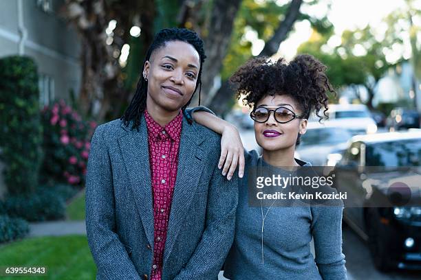 Portrait of lesbian couple, outdoors, smiling