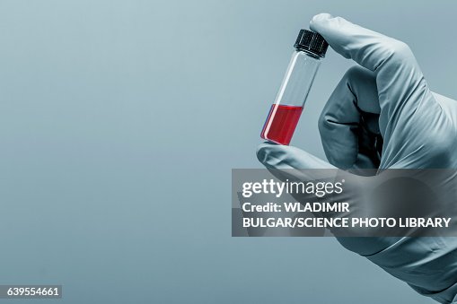 Person holding virology test tube Person holding virology test tube
