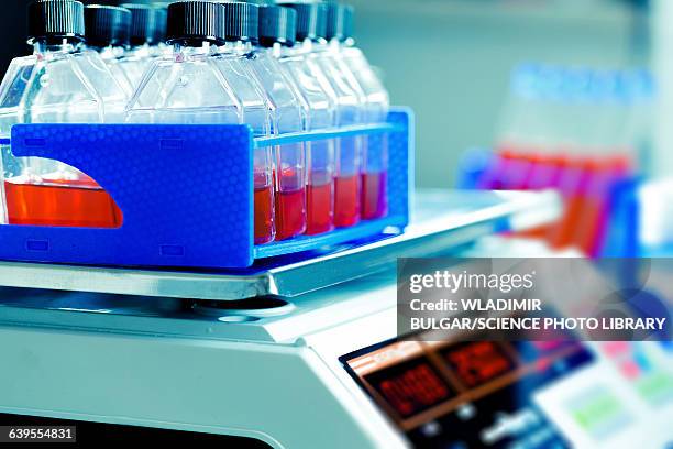 bottles containing red liquid - laboratory shaker stock pictures, royalty-free photos & images