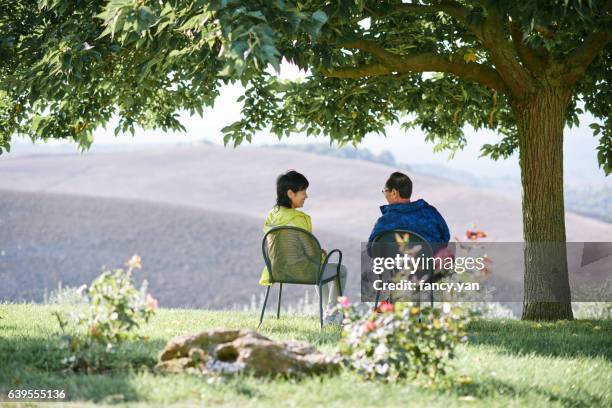 mature couple enjoying their vacations in holiday villa - agritoerisme stockfoto's en -beelden