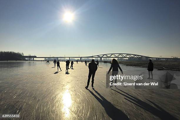 ice skating on a frozen lake in holland during winter - sjoerd van der wal or sjonature imagens e fotografias de stock