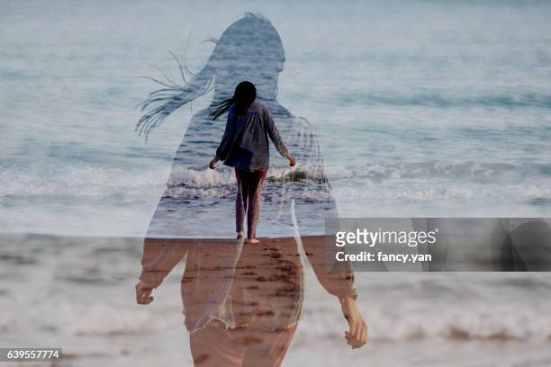 girl walking by seaside - espiritualidad fotografías e imágenes de stock