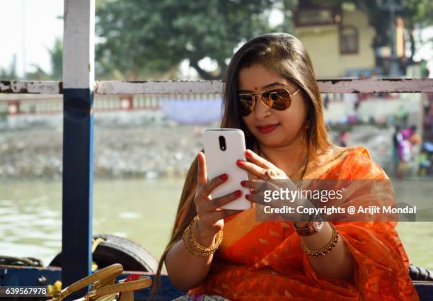 Indian Woman Using Cell Phone in Outdoor in Orange Sari