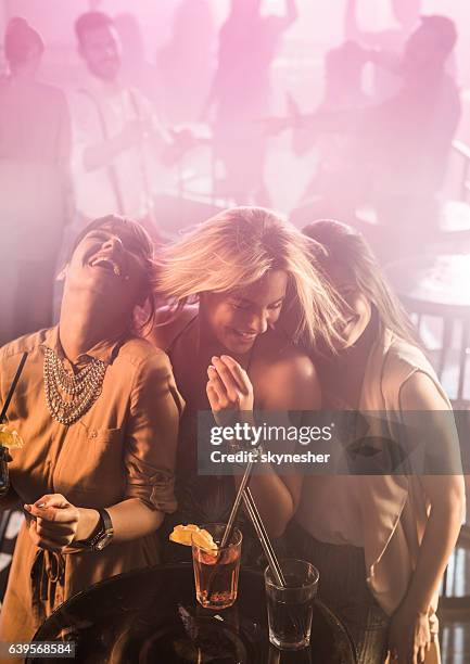 happy female friends disco dancing and clubbing together. - girls night out stockfoto's en -beelden