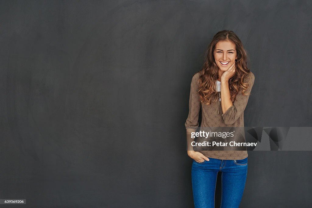 Smiling attractive woman at black background