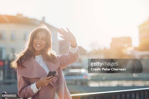 hello! - woman waving stock pictures, royalty-free photos & images