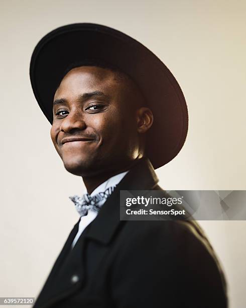 portrait of happy man wearing black suit and hat - black suit close up stock pictures, royalty-free photos & images