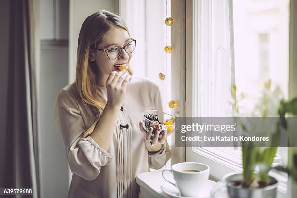 young woman at home - dried food stock pictures, royalty-free photos & images