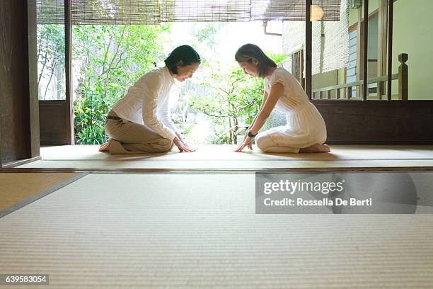 two japanese women bowing with respect - japanese greeting stock pictures, royalty-free photos & images