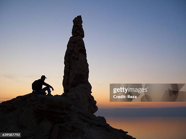 December 29 Southern shore of the Dead Sea, Al-Karak Governorate, Jordan."rStatue of Lot's wife, at dusk. According to the legend, the column made of...