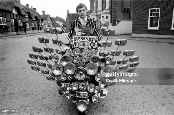 School leaver Bryn Owen aged 17 with his Vespa scooter, which has 34 mirrors and 81 lights on the front and back, all bought with his pocket money....