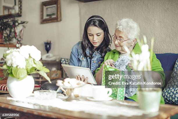 social worker is visiting a senior woman - parcel laptop stock pictures, royalty-free photos & images