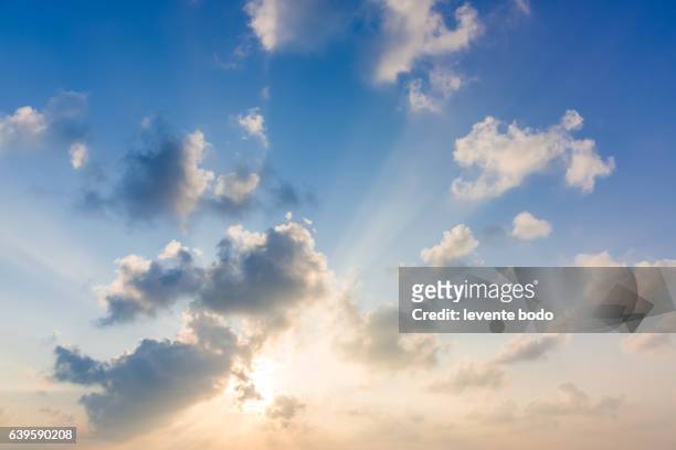 beautiful sky with clouds and sun. summer tropical beach sky clouds background concept design. - sunbeam clouds stock pictures, royalty-free photos & images