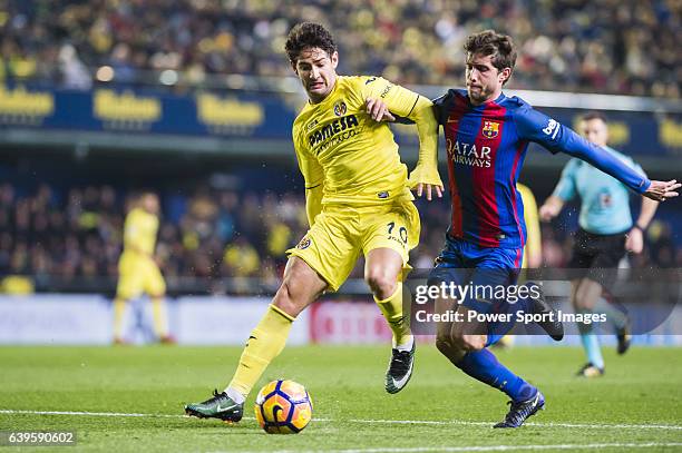 Alexandre Rodrigues da Silva "Pato" of Villarreal CF battles for the ball with Sergi Roberto Carnicer of FC Barcelona during their La Liga match...