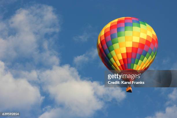 hot air balloon in rainbow colors - hot air balloon ride stock pictures, royalty-free photos & images