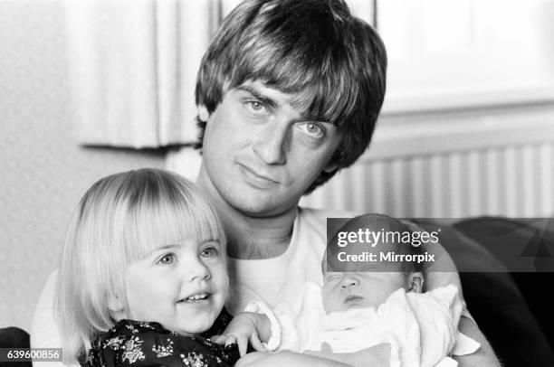 Mike Oldfield, musician and composer, pictured at home with family, eldest daughter Molly and baby son Dougal, Buckinghamshire, September 1981.