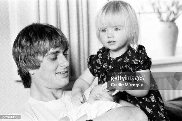 Mike Oldfield, musician and composer, pictured at home with family, eldest daughter Molly and baby son Dougal, Buckinghamshire, September 1981.