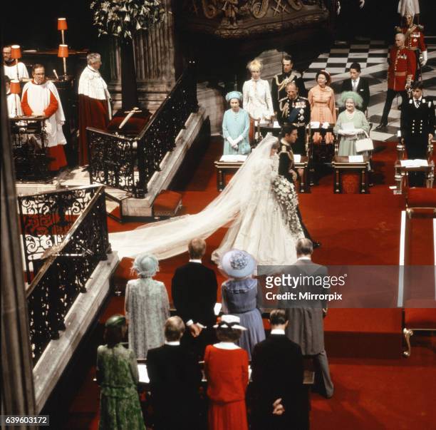 Princess Diana and Prince Charles walking down the isle being watched by both families after their wedding ceremony. There were 3,500 people in the...