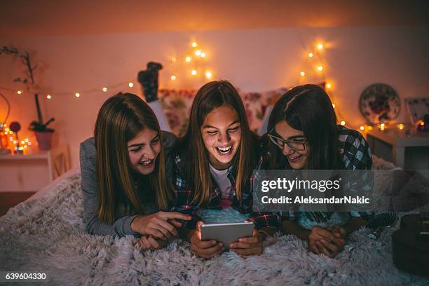 teenagers and social networking - girls slumber party devices stock pictures, royalty-free photos & images