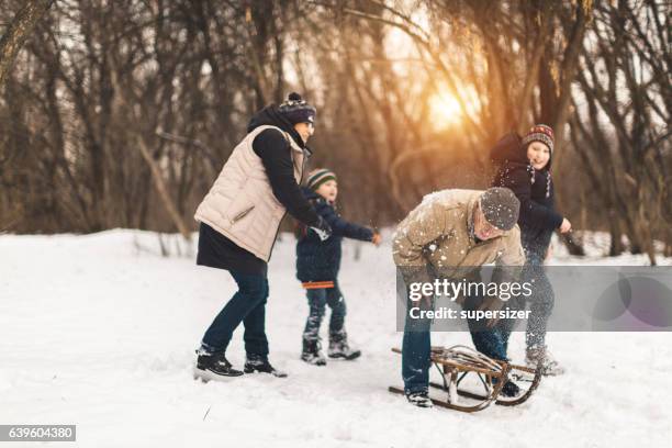 having fun outdoors - grandfather child snow winter stock pictures, royalty-free photos & images