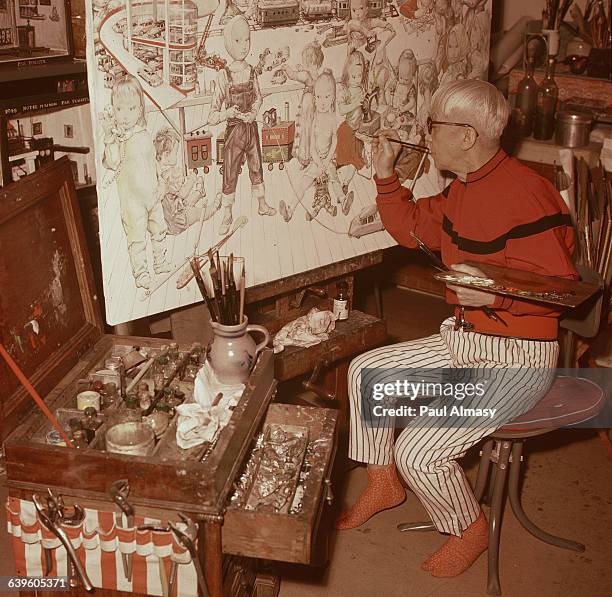 The artist Tsougharu Foujita at work on a painting of children playing. France, 1958.