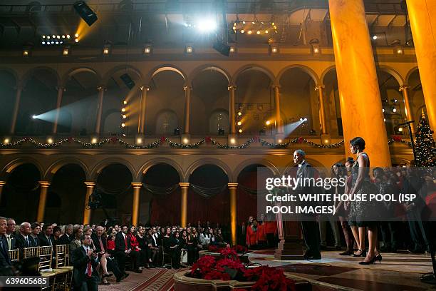 President Barack Obama, first lady Michelle Obama, and daughters Malia and Sasha join the performers on stage during TNT's "Christmas in Washington"...