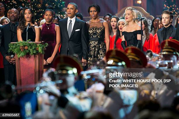 President Barack Obama, first lady Michelle Obama, and daughters Malia and Sasha join the performers on stage during the taping of TNT's "Christmas...