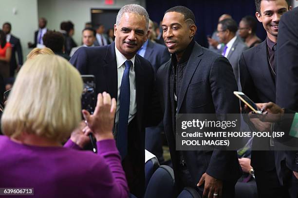 Former Attorney General Eric Holder poses for a photograph with hip-hop artist Ludacris during a gathering of criminal actors, hip-hip artists,...