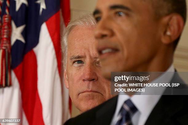 President Barack Obama, standing with Vice President Joe Biden, delivers remarks in the East Room of the White House in Washington, Tuesday, July 14...