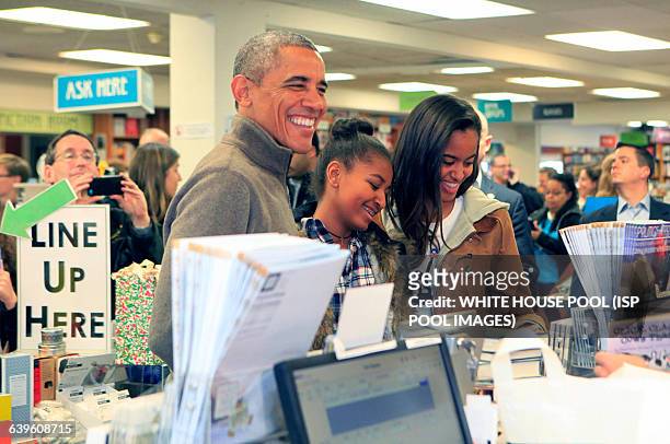 President Barack Obama and daughters Sasha, on left , and Malia,, purchase books at the bookstore Politics and Prose in Northwest Washington, DC on...
