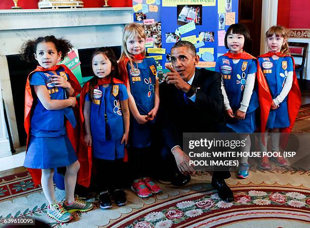 Us President Barack Obama poses with a group of 6 years old Girls Scouts from Tulsa Oklahoma who designed a battery powered page turner to help...