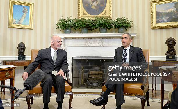 President Barack Obama speaks to Afghan President Ghani during a restricted bilateral meeting in the Oval Office of the White House March 24, 2015 in...