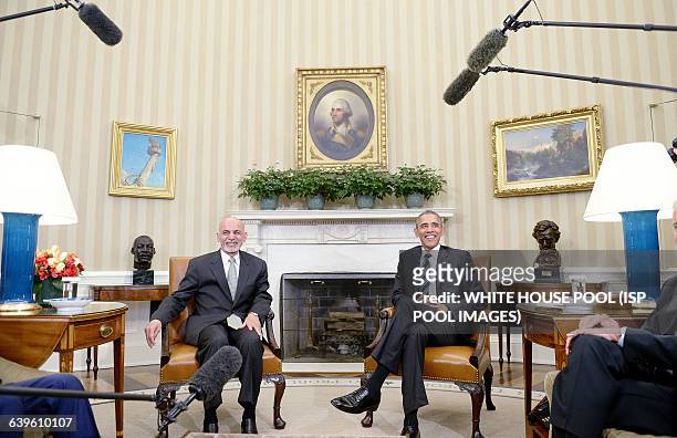 President Barack Obama poses with Afghan President Ghani during a restricted bilateral meeting in the Oval Office of the White House March 24, 2015...