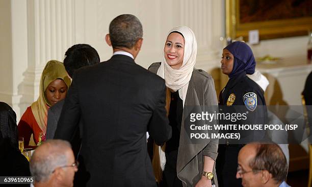 President Barack Obama greets Samantha Elauf,the muslim woman who was denied a job over head scarf at Abercrombie & Fitch during an Iftar dinner...