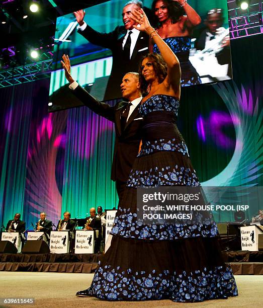 President Barack Obama and First Lady Michelle Obama wave on stage after President Obama delivered remarks at the Congressional Black Caucus...