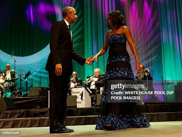 President Barack Obama and First Lady Michelle Obama wave on stage after President Obama delivered remarks at the Congressional Black Caucus...