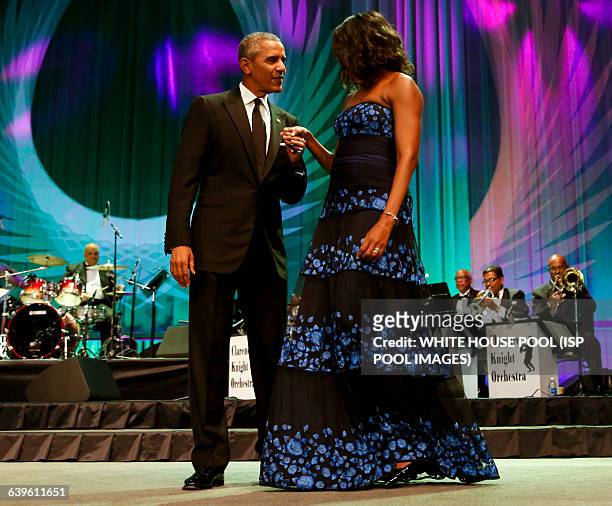 President Barack Obama and First Lady Michelle Obama wave on stage after President Obama delivered remarks at the Congressional Black Caucus...