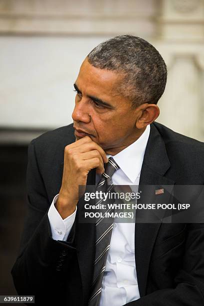 President Barack Obama listens to German President Joachim Gauck speak to the media before the two held a bilateral meeting in the Oval Office of the...