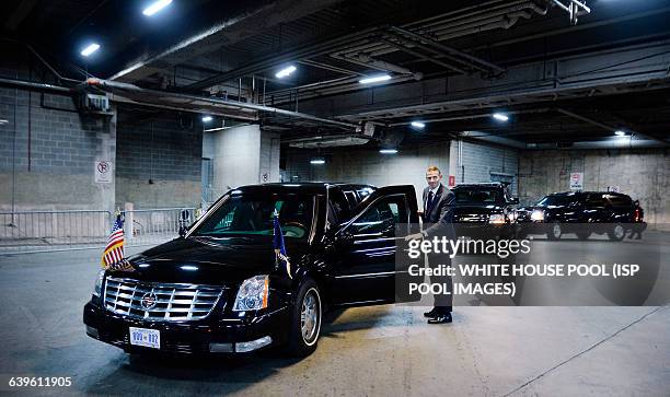 Secret Service Agent stands still next to U.S. President Barack Obama's car named "the beast" in a underground parking at the Congressional Hispanic...