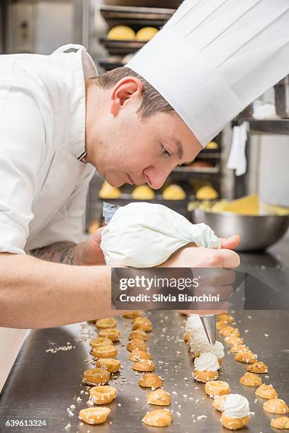 chef préparant la pâtisserie avec un sac de glace - pâtissier photos et images de collection