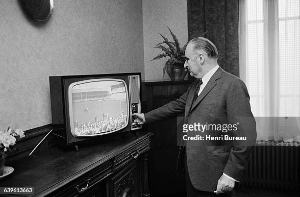 French President Georges Pompidou tunes into the final match of the rugby French Cup during his electoral campaign in the Cantal region.
