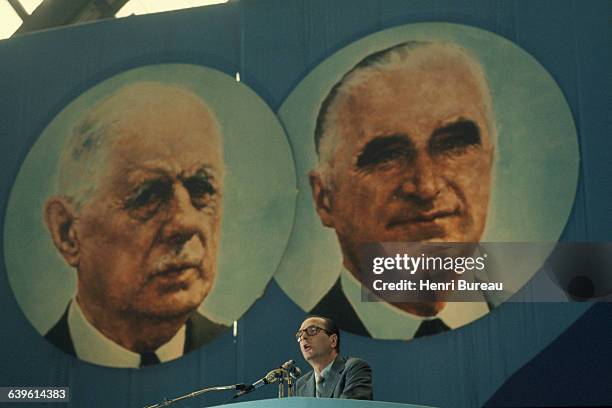 Prime Minister Jacques Chirac gives a speech as he resigns from his position of General Secretary of UDR, in front of portraits of Charles de Gaulle...