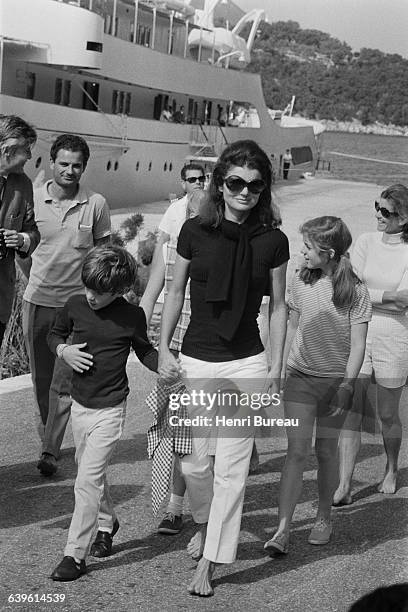 Former First Lady of the United States Jacqueline Kennedy Onassis on vacation on the Greek island of Skorpios with her children John and Caroline.