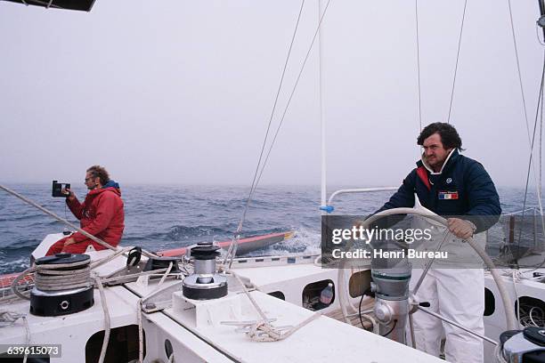 French sailor Olivier de Kersauson and crewman Gerard Djikstra attempt the Franco-British Double Transat abord the trimaran Jacques Ribourel, which...