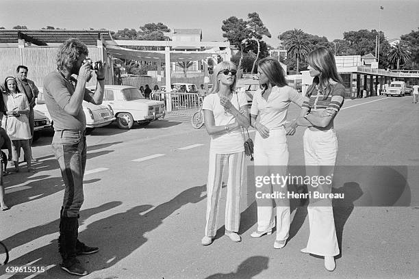 French singer and actor Johnny Hallyday taking picture of his wife Bulgarian-born French singer Sylvie Vartan, and French singers Sheila and...