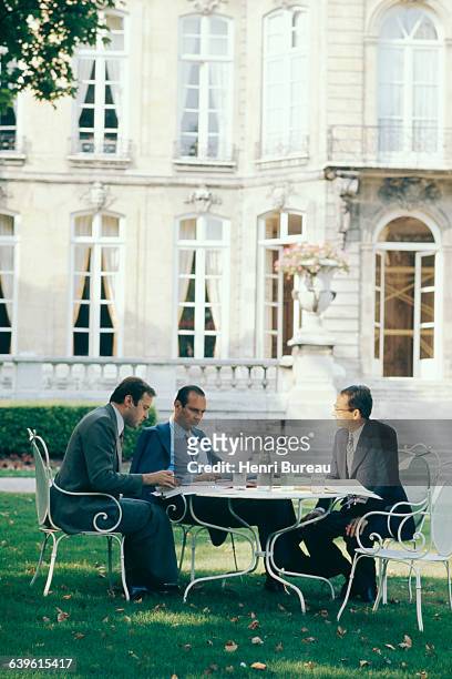 French Prime Minister Jacques Chirac in the garden of the Hotel Matignon with adviser Jacques Toubon and chief of staff FranÃ§ois Heilbronner.